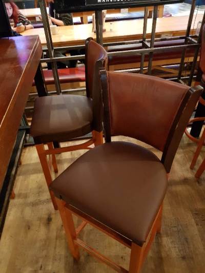 The re-upholstery of a bar stool