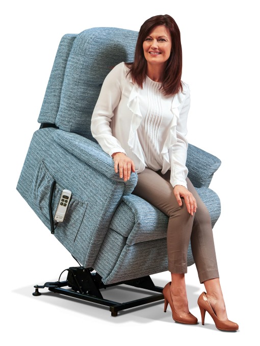 Lady testing a rise and recliner chair after a repair has been completed